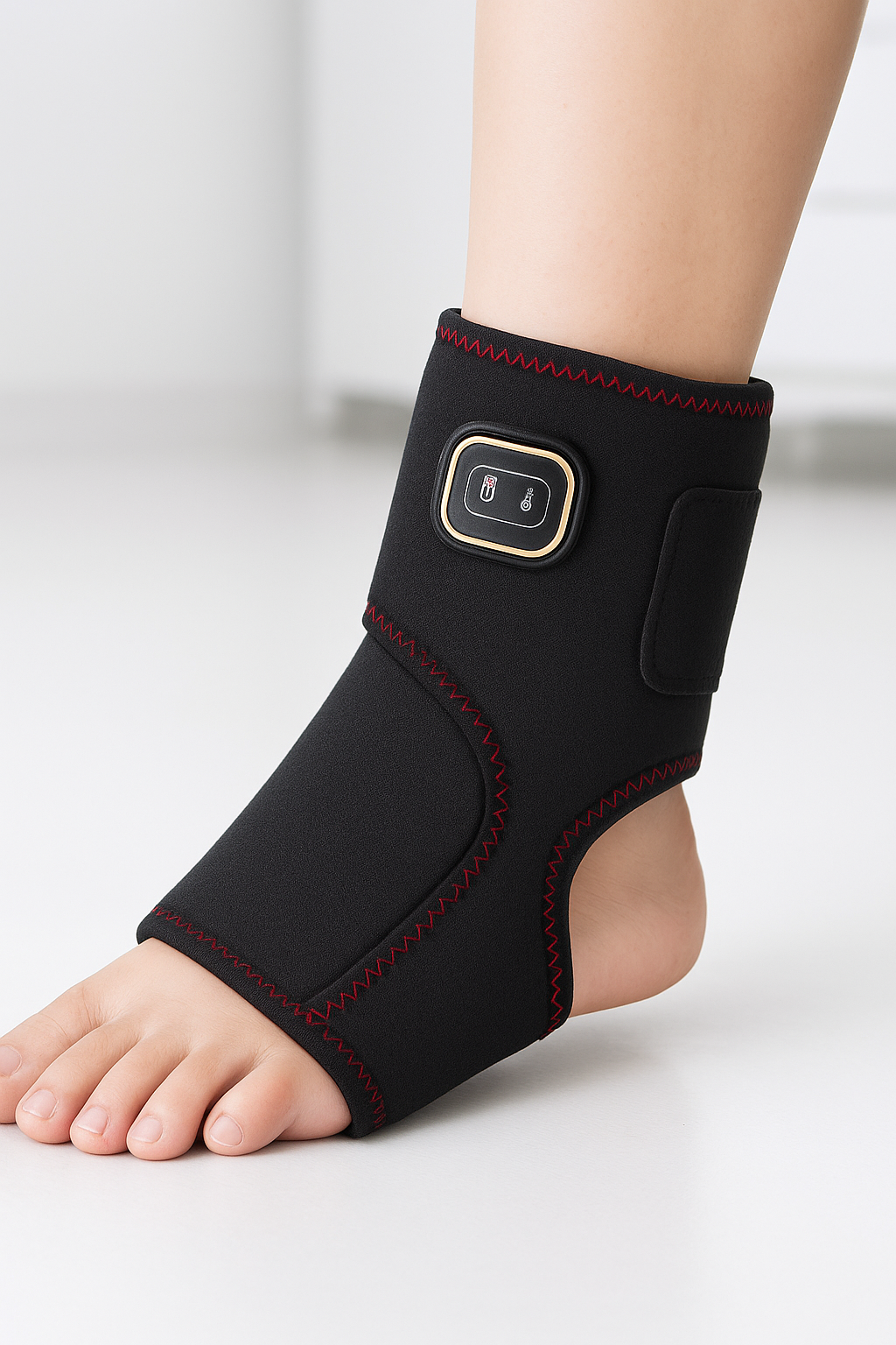 Black ankle support brace with electronic component on a white background